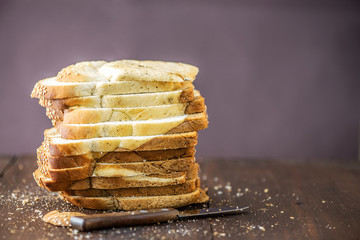 Sliced of marble bread on rustic wooden table. With copy space