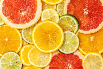 Fototapeta na wymiar Mixed Fresh slices citrus fruit as background. Top view