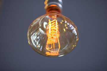Beautiful hanged orange decoration light bulbs focus on pear shape like one in the coffee shop
