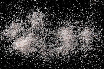 Himalayan salt pile isolated on black background, top view