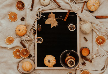 Flat lay Autumn composition. Pumpkins, cinnamon sticks, candles, dried leaves on cozy background. Autumn, fall, halloween concept. top view, copy space