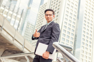 business and office concept . Young Asia handsome buisnessman showing thumbs up.