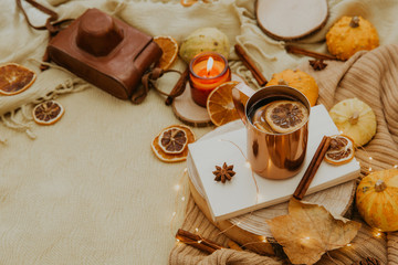 Cozy autumn composition with hot tea, donut and fall decorations