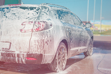 .Car wash self-service. The owner washes his car.