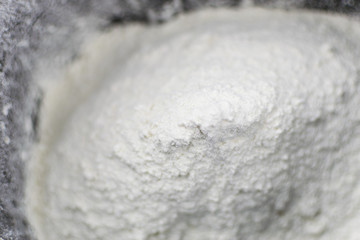 Flour poured into the breadmaker's capacity.