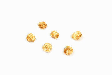 A few pieces caramel popcorn on white background.