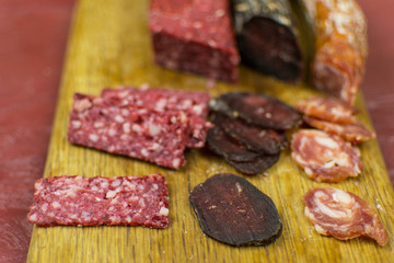 Smoked sausages are cut on a cutting board.