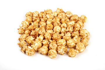 Pile of caramel popcorn on white background.