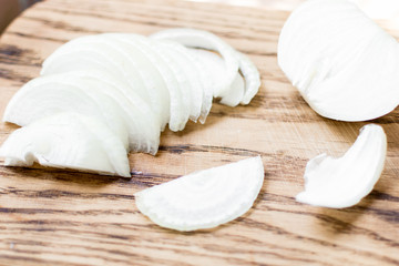 Fototapeta na wymiar Sliced onions on a wooden background.