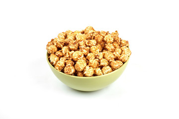 caramel popcorn in a bowl on a white background