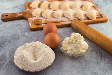 Ingredients for making dumplings with filling-flour, eggs, cottage cheese.