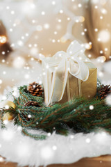 winter holidays and decorations concept - christmas gift and fir wreath with cones and balls at...