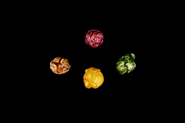 multicolored caramel popcorn on a black background.