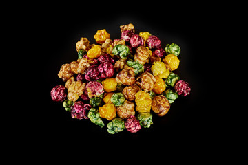 multicolored caramel popcorn on a black background.