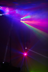 Stage lights in action at the concert. Lights show. Lazer show. Night club dj party people enjoy of...