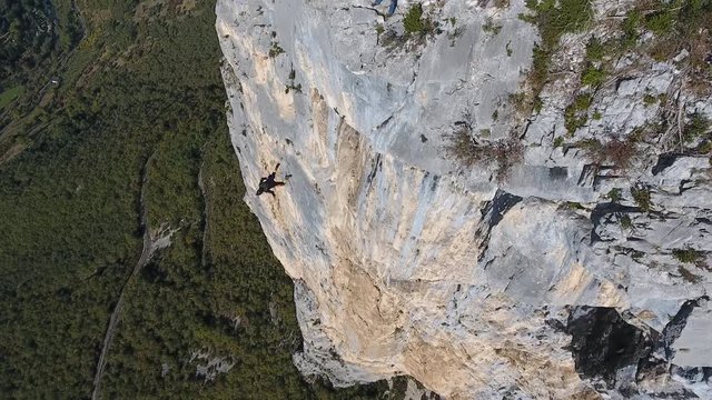 Following by drone a man base jumping from a cliff in Choranche France.