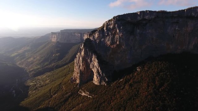 Aerial drone shot flying towards a mountain in vercors massif France. Sunset time.