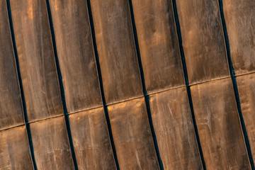 Details of rusty steel structural sheets, used for external roofing surface in organic architectural design. Surface with zinc traces, contemporary architecture for public events, arty place.