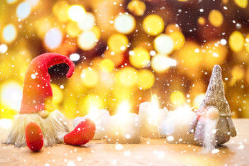 Two christmas dwarfs in falling snow with bokeh lights in background - 229532051