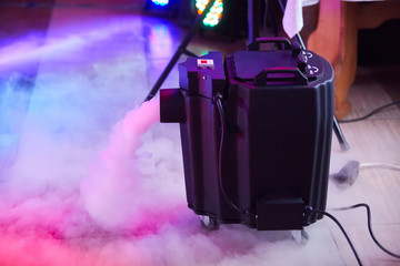 Modern smoke/fog (dry ice) device in action. This electric machine releases fog to the stage 