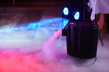 Modern smoke/fog (dry ice) device in action. This electric machine releases fog to the stage