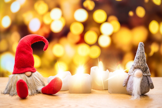Two christmas dwarfs with bokeh lights in background