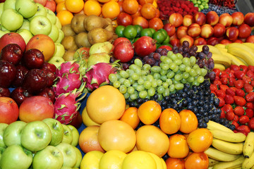 Naklejka na ściany i meble Farmers market with various colorful fresh healthy fruits for sale. A big choice of ripe various fresh fruits on market