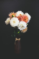 Dahlia flowers in vase. Pink, yellow and white dahlias. Autumn flowers, decorated with pumpkins