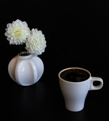 Cup of tea or coffee in the autumn at home. Decorated with dahlia, reading a book