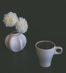 Cup of tea or coffee in the autumn at home. Decorated with dahlia, reading a book