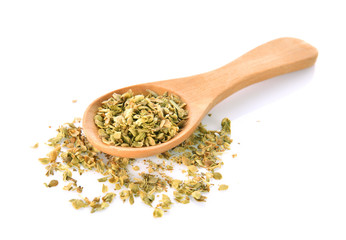 dry oregano leaves on bamboo spoon and on white background
