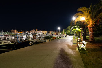 Fototapeta na wymiar Night view of seafront with boats in Budva summer season, Montenegro.