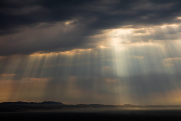 Dramatic cloud formations with the rays of the sun shining through at Jeffreys Bay in South Africa