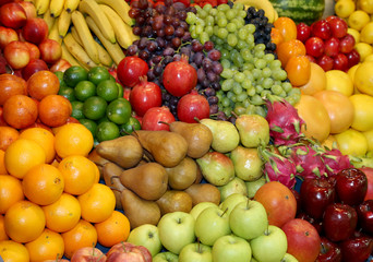 Naklejka na ściany i meble Farmers market with various colorful fresh healthy fruits for sale. A big choice of ripe various fresh fruits on market