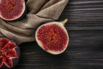 Cut ripe figs on wooden table