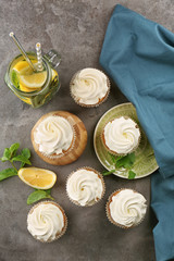 Composition with sweet cupcakes and lemonade on grey table