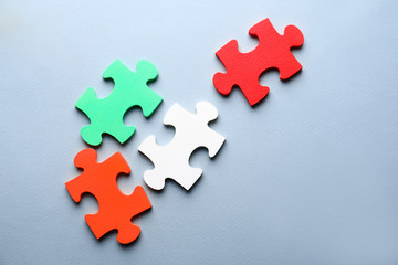 Pieces of puzzle on color background