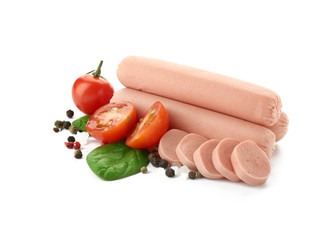 Delicious sausages with tomatoes and spices on white background