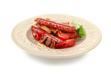 Plate with delicious grilled sausages and vegetables on white background