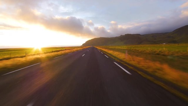Road view driving in Iceland amazing sunset. Fast speed