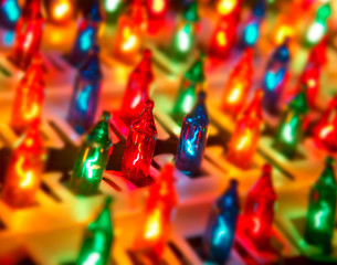 ROW OF DIFFERENT COLOURED CHRISTMAS LIGHTS IN CLOSE UP