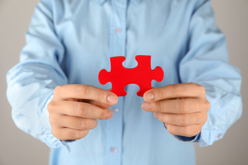 Fototapeta premium Woman with piece of color puzzle, closeup