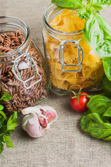 Ingredients of the cook - pasta, garlic, basil and tomato