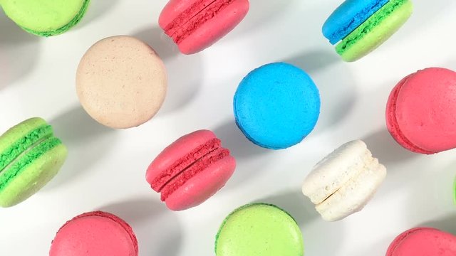 Cake macaron or macaroon on white background from above, rotation colorful cookies. Top view.