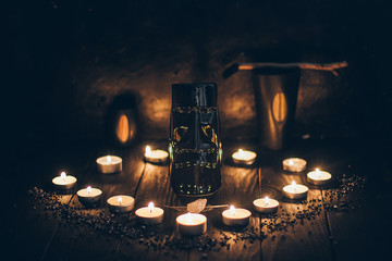 A ritual halloween witchcraft scene with candles, tiki statue on the rustic background 