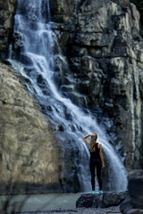 young woman in the waterfall