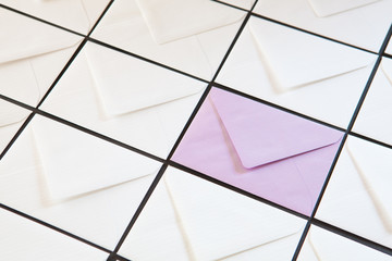 Composition with white and purple envelopes on the table.