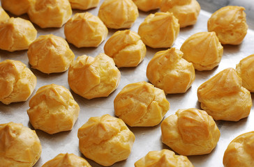 Profiteroles in the oven. Eclair. Homemade Cream Puffs. 