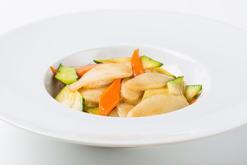 Grilled rice gnocchi with vegetables in white dish