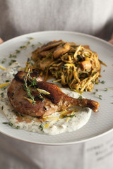 baked duck leg with vegetables and sauce